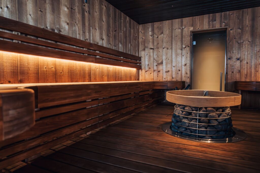HIVE electric sauna heater is a stylish option for bigger saunas, ideal for spas or gyms. The beehive-inspired design of the HIVE electric heater brings out the natural beauty of stones. It’s designed to hold an impressive 270 kg of sauna stones, providing gentle and rich steam for even longer sauna sessions. The details of the heater are made of durable stainless steel. The HIVE’s round shape allows it to be placed in the center of the room, making it perfect for groups or families. Its Nordic, natural design creates a peaceful ambiance that helps you relax and unwind.
